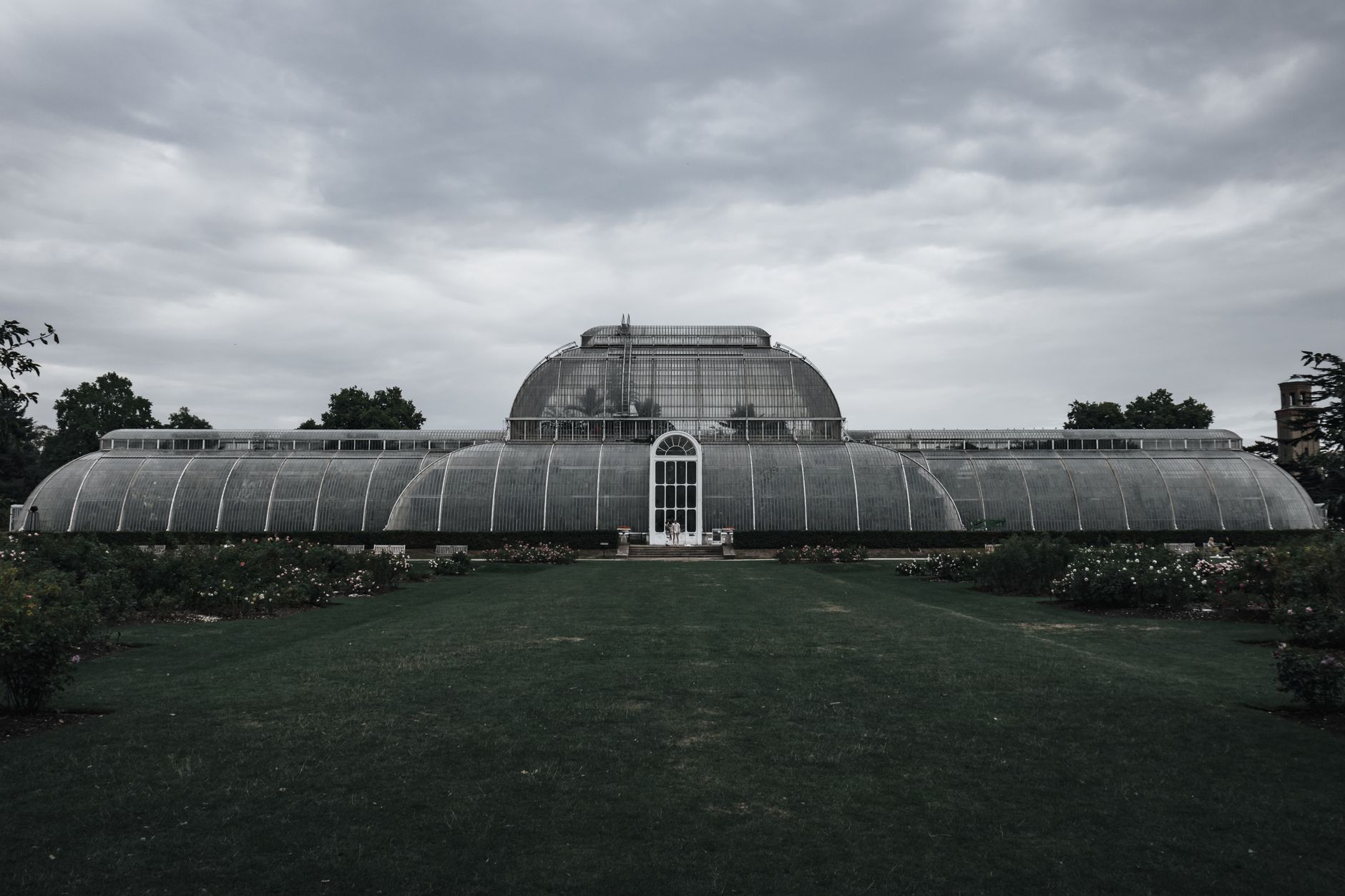 A Kew Gardens üvegházainak frontális nézete felhős ég alatt